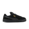 Black suede lace-up sneakers with Puma logo on side and textured platform sole