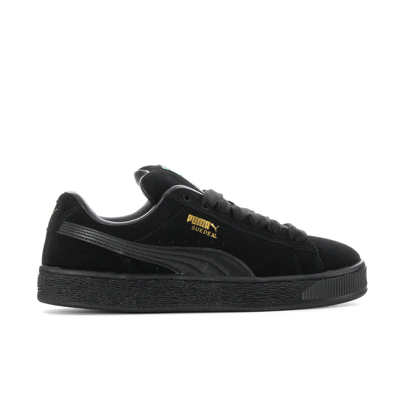 Black suede lace-up sneakers with Puma logo on side and textured platform sole