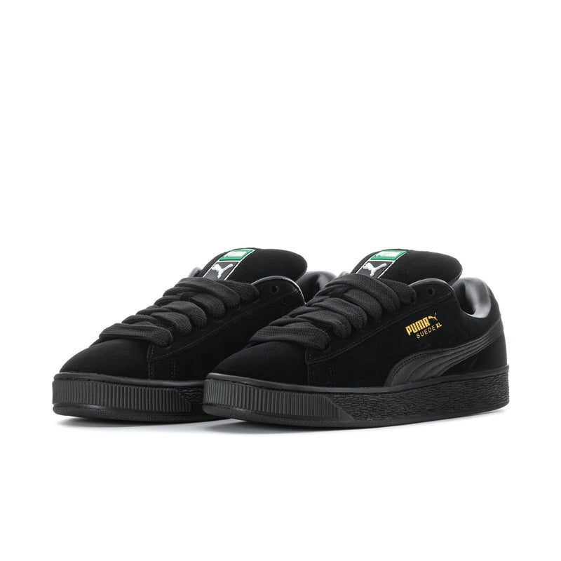 Pair of black suede lace-up sneakers with side Puma stripe and platform rubber sole