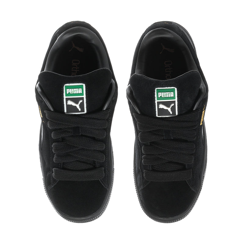 Black suede sneakers front view with Puma tongue label and lace-up design