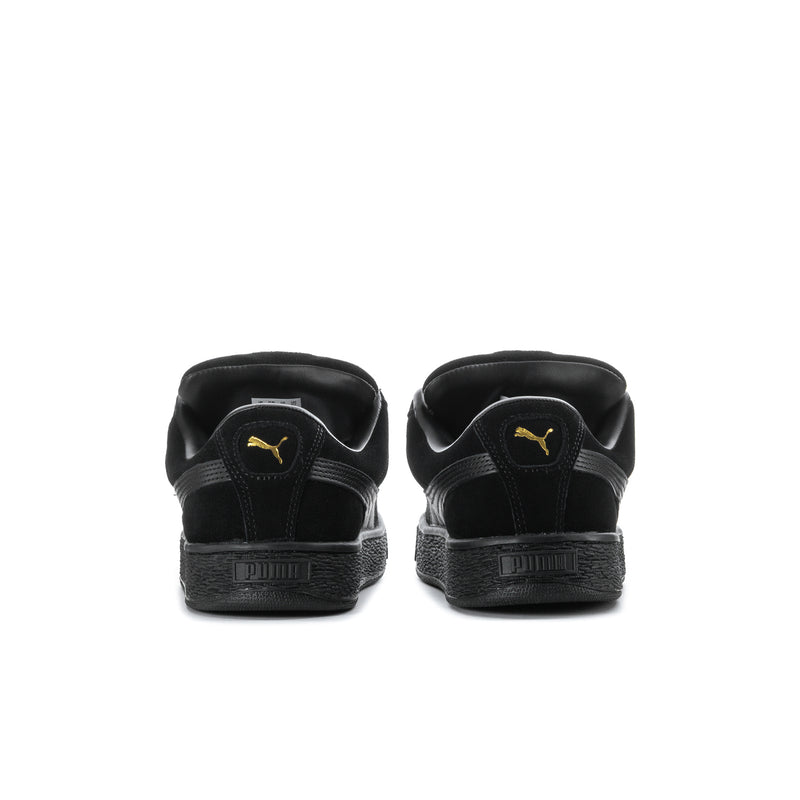 Black suede sneakers with rear Puma logo and chunky textured platform sole