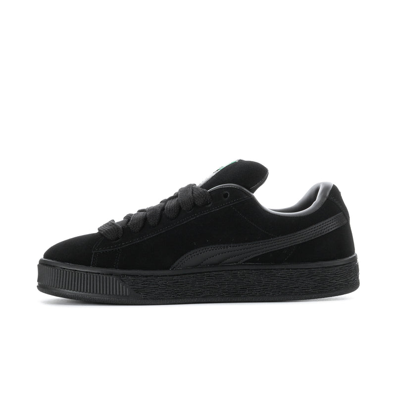 Black suede lace-up sneakers in side profile with Puma stripe detail and platform sole