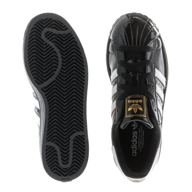 Women’s sneaker sole and side view: black rubber outsole with tread pattern