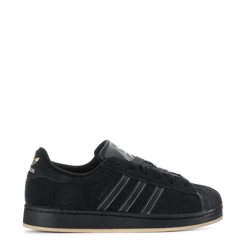 Youth black low-top sneakers with three-striped design and lace-up closure.