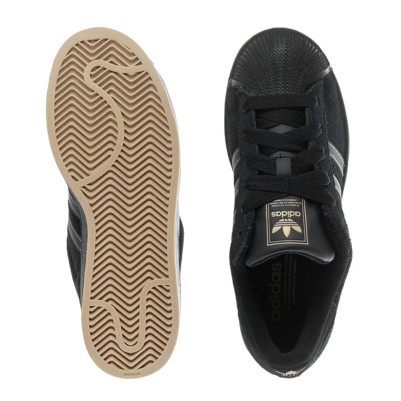 Youth black sneakers showing rubber outsole and lace-up upper with adidas tongue logo.