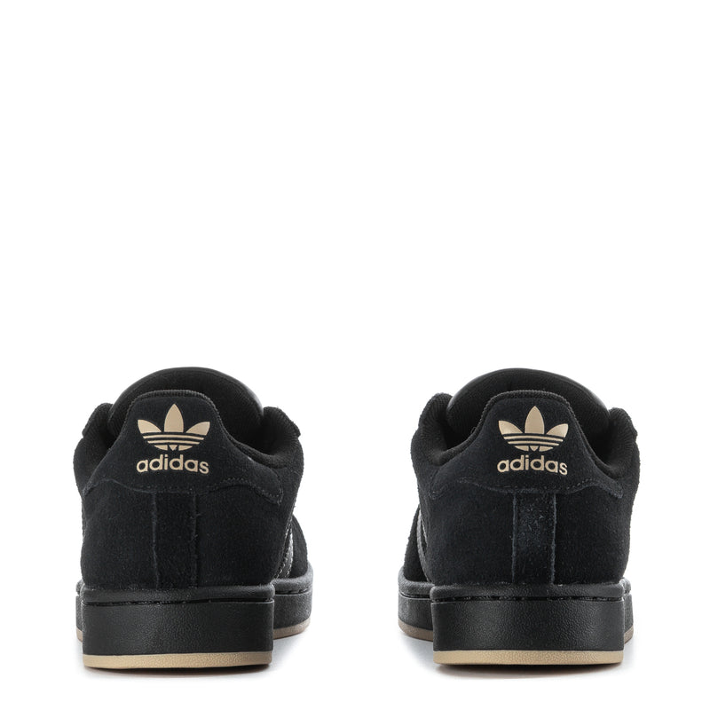Youth black sneakers, heel view with adidas logo and low rubber sole.