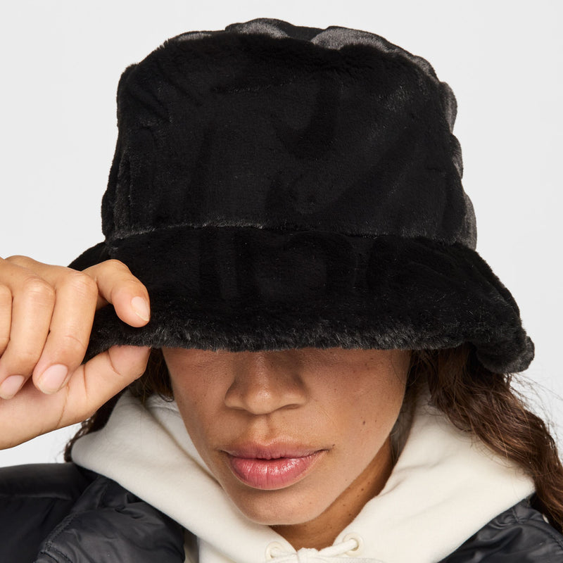 Black faux fur bucket hat close-up, soft textured brim and band