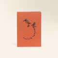 Front cover of a book orange with black blue and gold abstract calligraphy designs