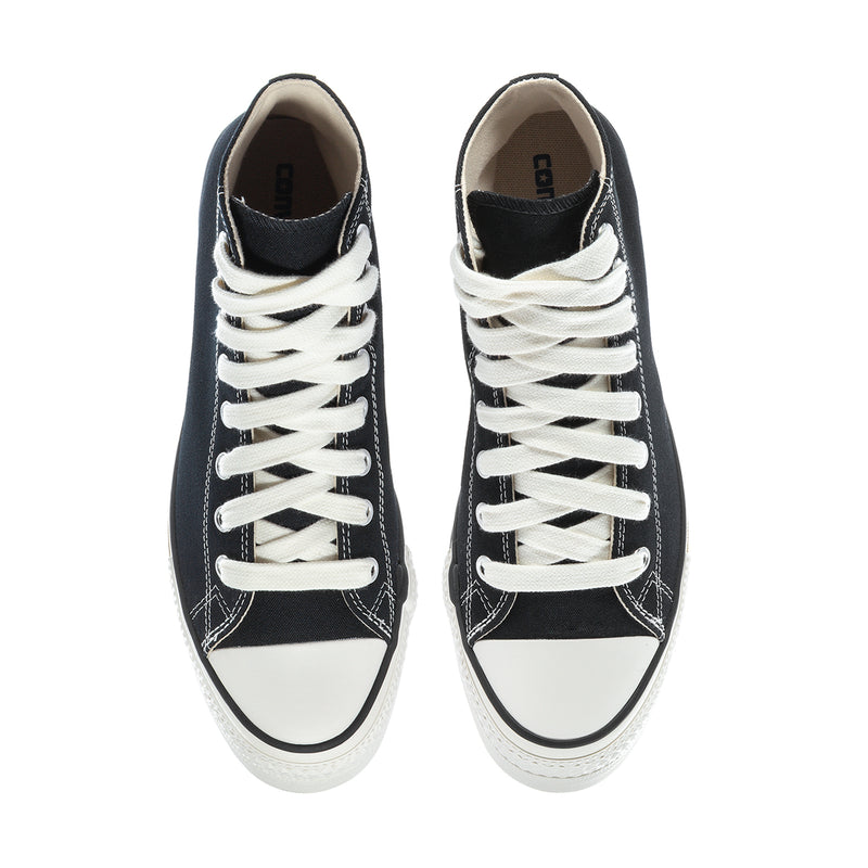 Black high-top sneakers viewed from above, white laces and rubber toe caps