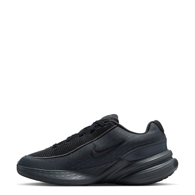 Youth dark running shoe side view with lace-up upper and swoosh detail
