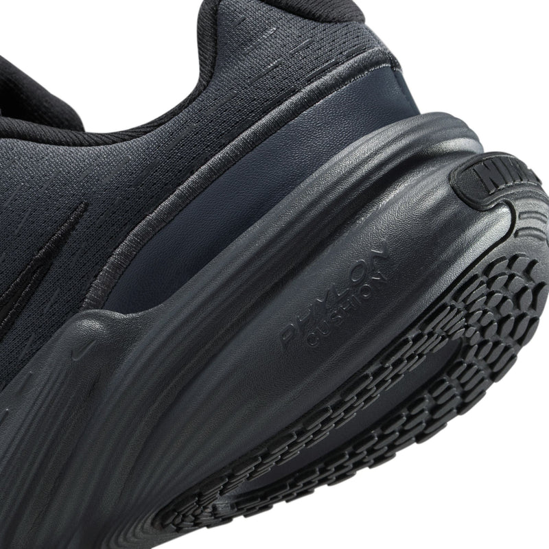 Youth dark sneaker side close-up with cushioning midsole and treaded outsole