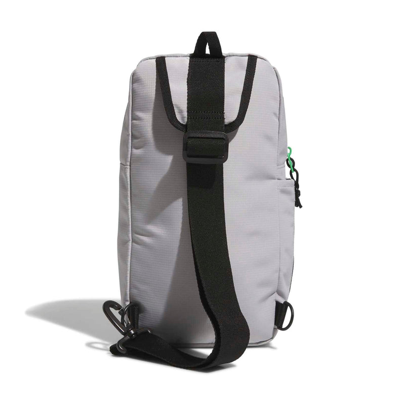 Light grey sling bag with black back strap, zippered front pocket, green side loop