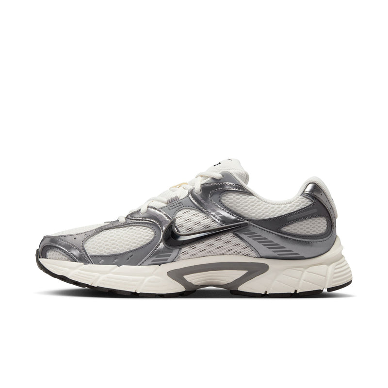 Men's athletic sneaker side profile with dark gray overlays, white midsole, and sculpted lines