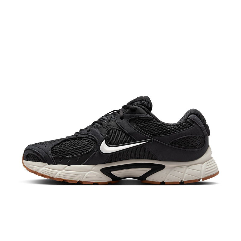 Men's black Nike running shoes side view with swoosh and white midsole
