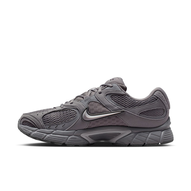 Grey running shoe side view with mesh panels, lace-up, and Nike Swoosh.
