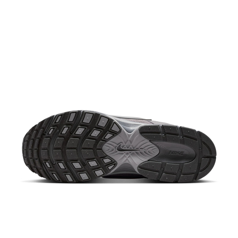 Grey outsole of running shoes with deep tread pattern and durable rubber sections.