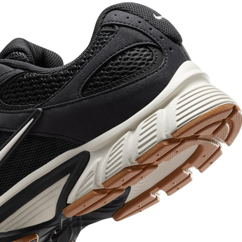 Men's black Nike running shoes close-up of sidewall and textured outsole with brown tint