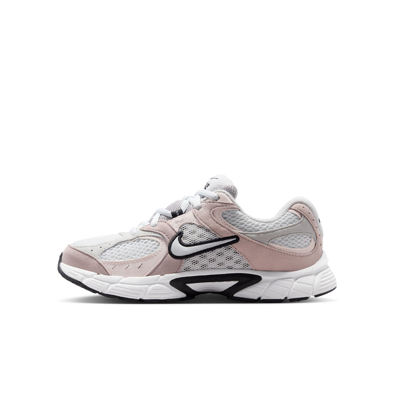 Youth athletic sneakers, side profile in off-white, pink, and gray with swoosh.