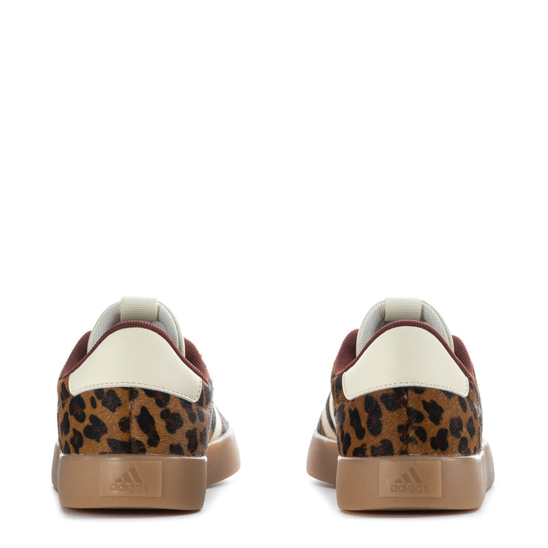 Women’s low-top sneaker back view, cream heel tab, leopard upper, gum sole
