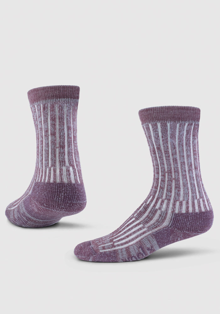 The Woolx Joey Crew Socks - Wildflower, featuring purple and white stripes, are made from premium Australian Merino wool and displayed against a white backdrop. These midweight socks boast a ribbed texture along with reinforced heels and toes, shown both side-on and slightly angled to highlight their design. They are Woolmark Certified for quality assurance.
