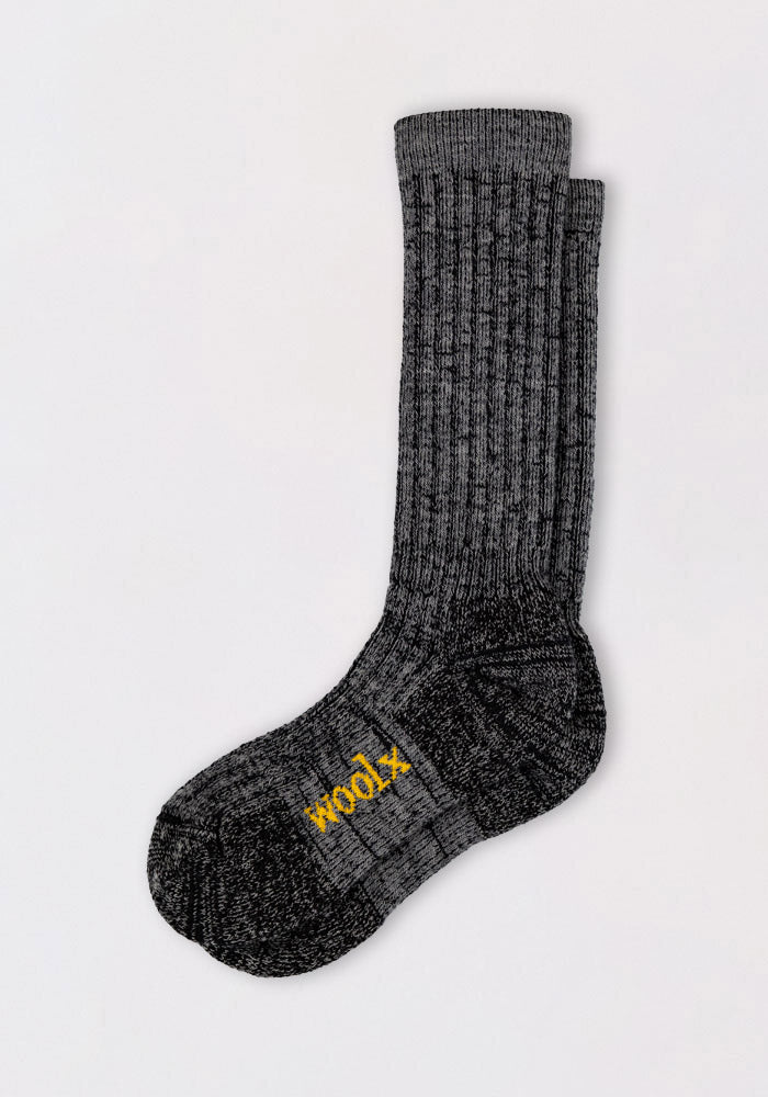 A pair of Womens Joey Mid Calf Socks by Woolx in dark navy marled, stacked together with "WOOL" in yellow on the sole, are displayed on a plain white background.