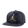 Youth black snapback cap with gold Jumpman logo and jacquard pattern, flat brim